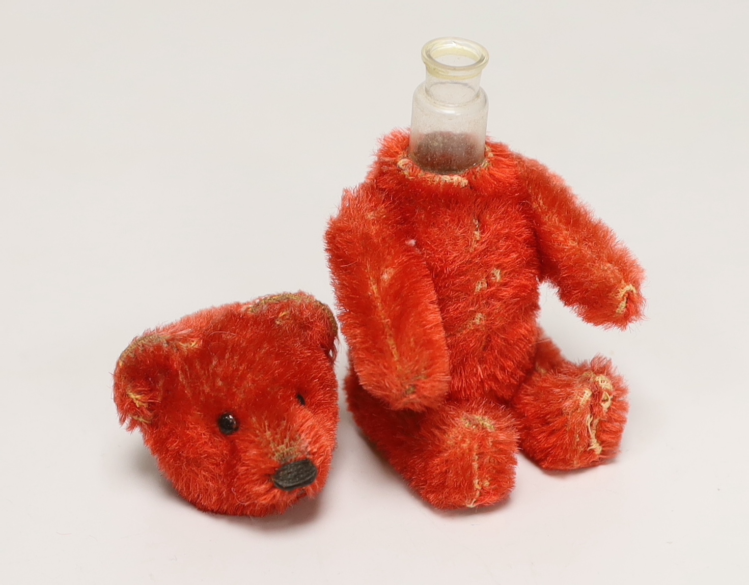 A red Schuco perfume bear, c.1920s, 5in., in excellent condition, missing stopper